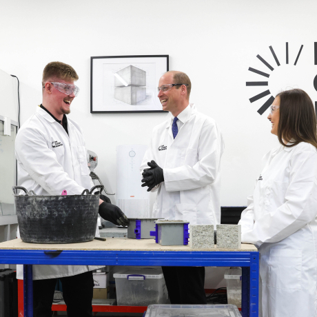 The Prince of Wales visits Low Carbon Materials, pictured meeting staff in a lab coat and gloves
